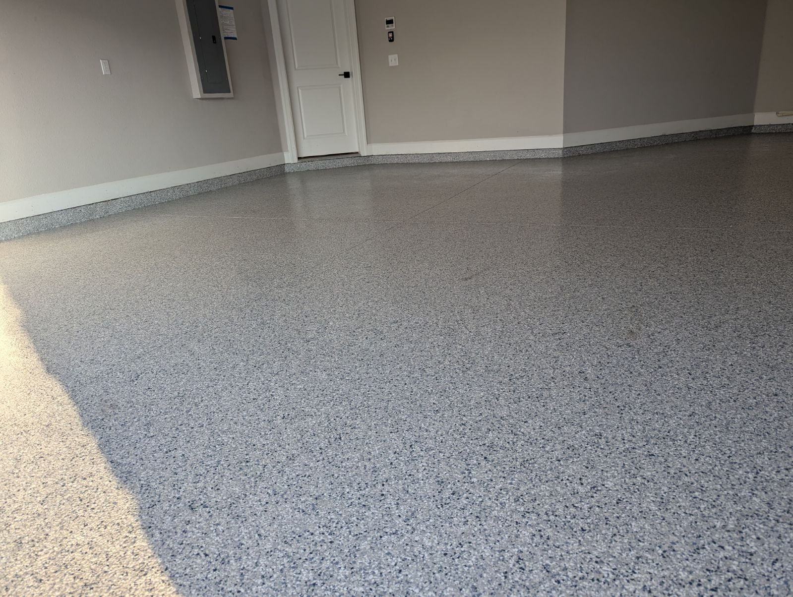 Large commercial bay with silver and black metallic floor coating