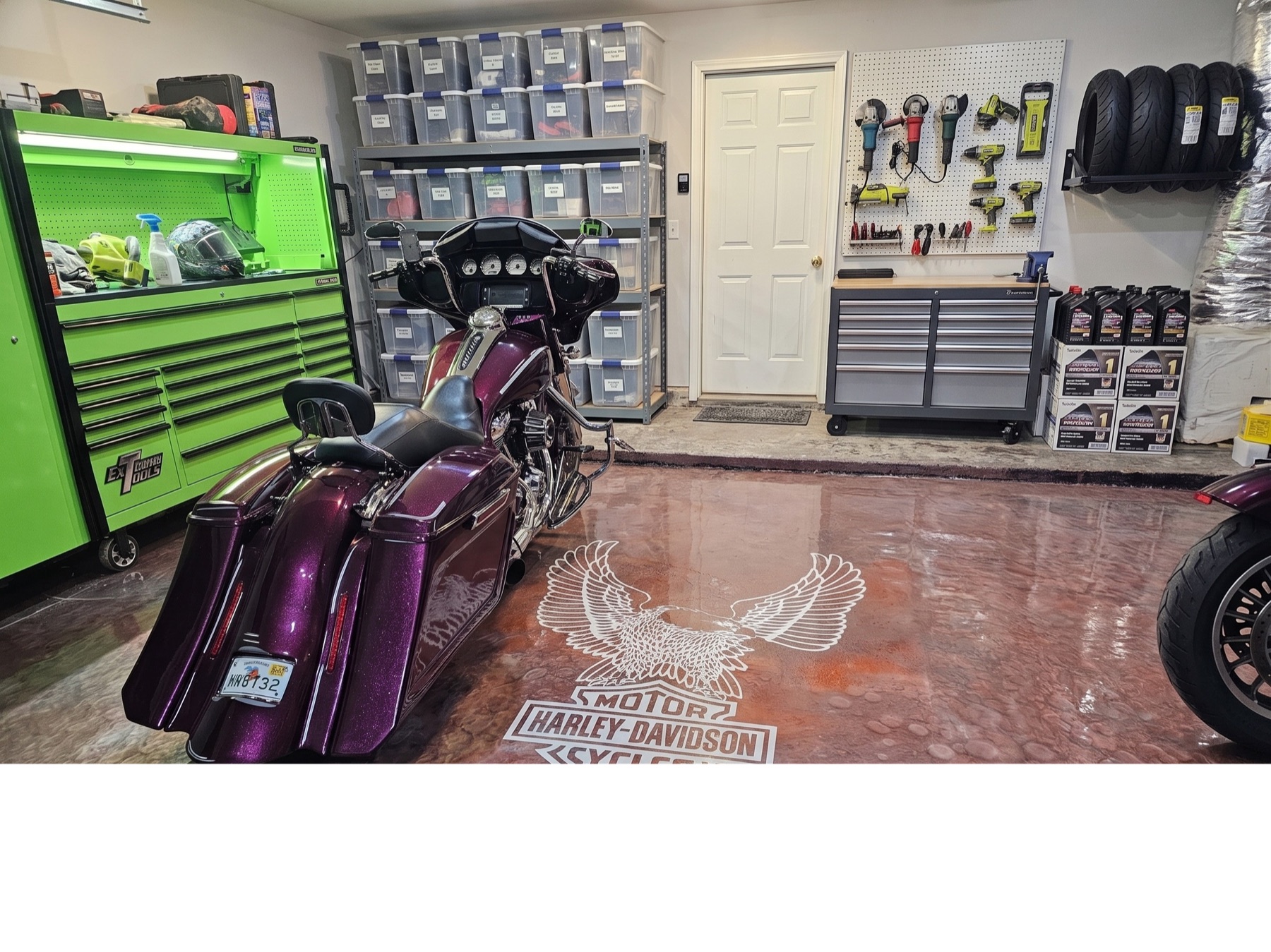 Custom copper-metallic garage floor with parked Harley-Davidson and 'The Lloyd's' stencil, Northeast Florida