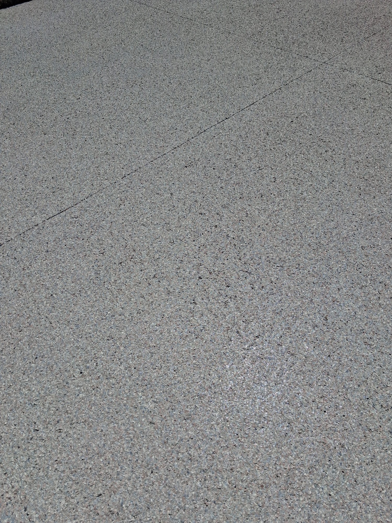 Fresh grey flake driveway with dramatic shadow line