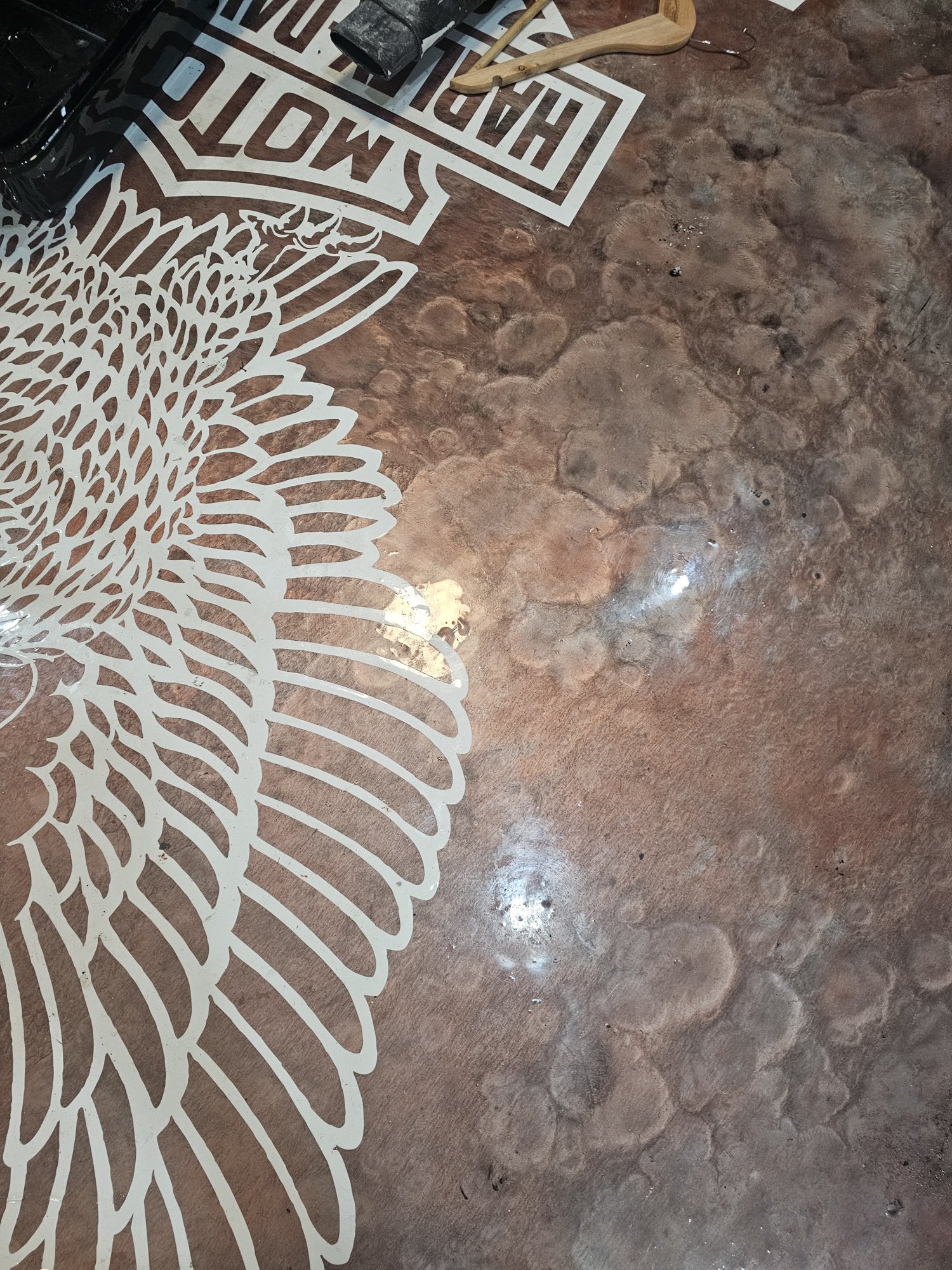 Close-up of copper Harley-Davidson stencil on metallic garage floor