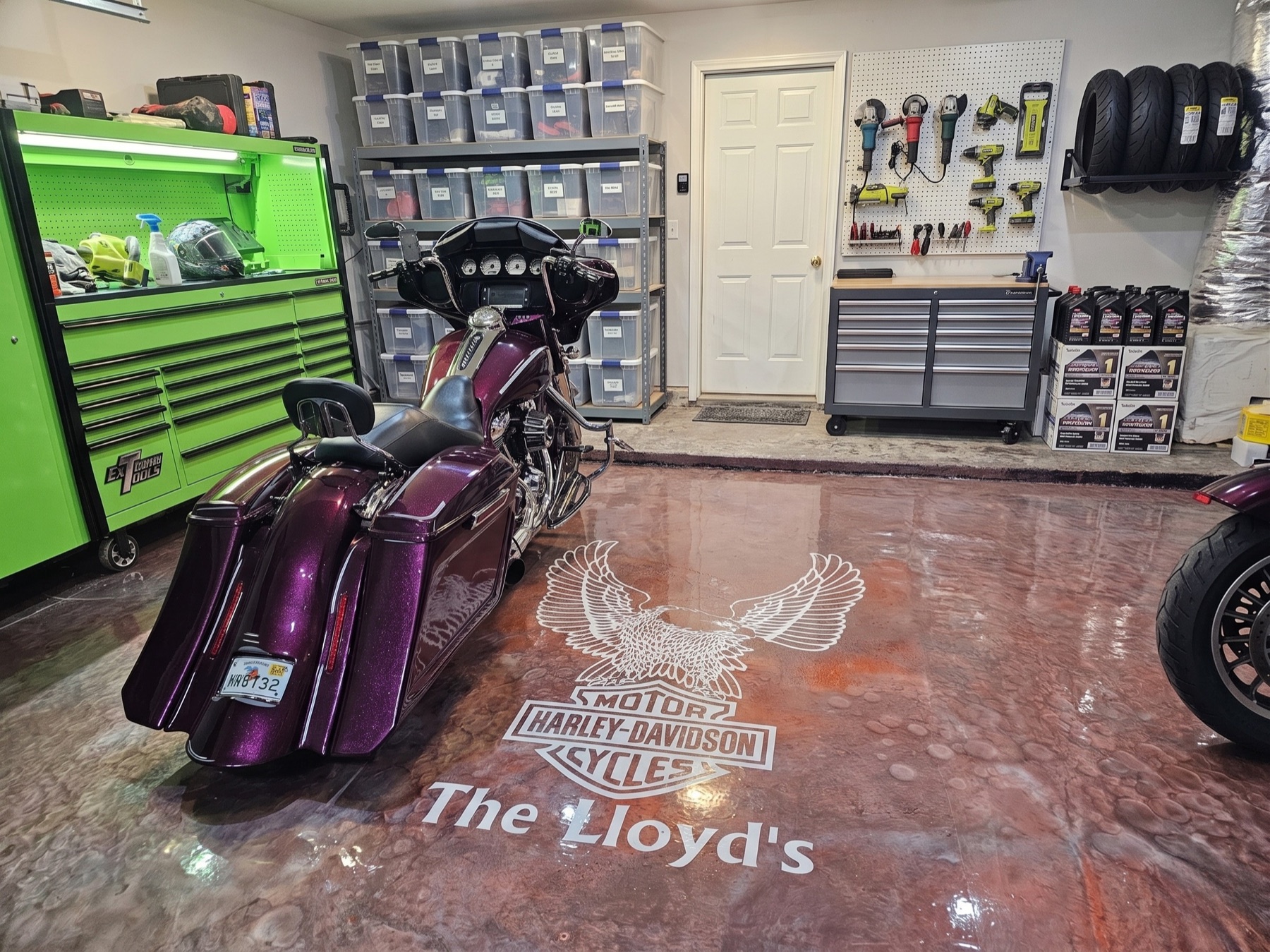 Custom copper-metallic hot-rod garage floor with parked Harley-Davidson and 'The Lloyd's' stencil
